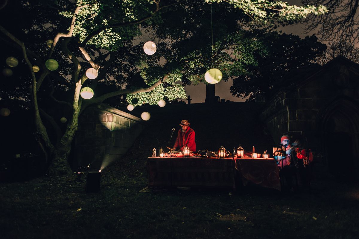 Musician Laraaji, accompanied by Arji OceAnanda, played his dulcimer under a tree studded with lanterns.