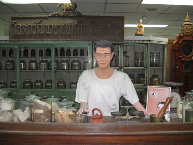 A mannequin pharmacist tends the apothecary.