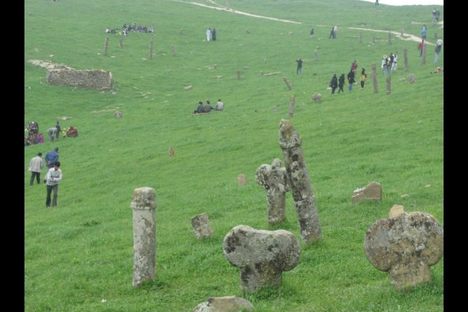 Visitors wander amongst the oddly-shaped headstones