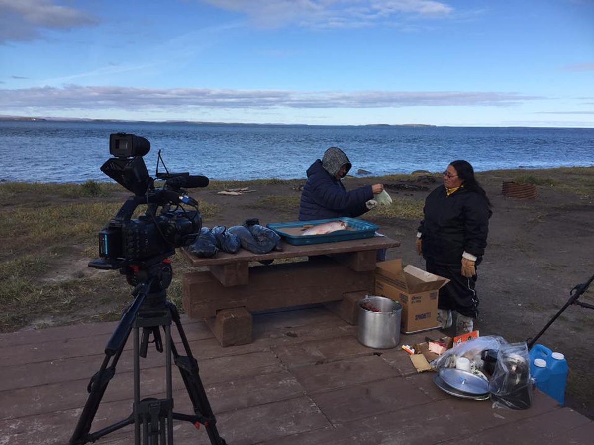 One filming day involved cooking fish and caribou legs on a beach in Kugluktuk.