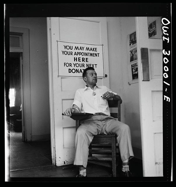 After donating blood at a Red Cross center in Washington, D.C., a man waits for his free cup of coffee.