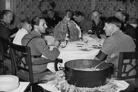 A propaganda image from 1933 claimed to show Hitler enjoying an Eintopf meal—though in real life he seldom ate meat.