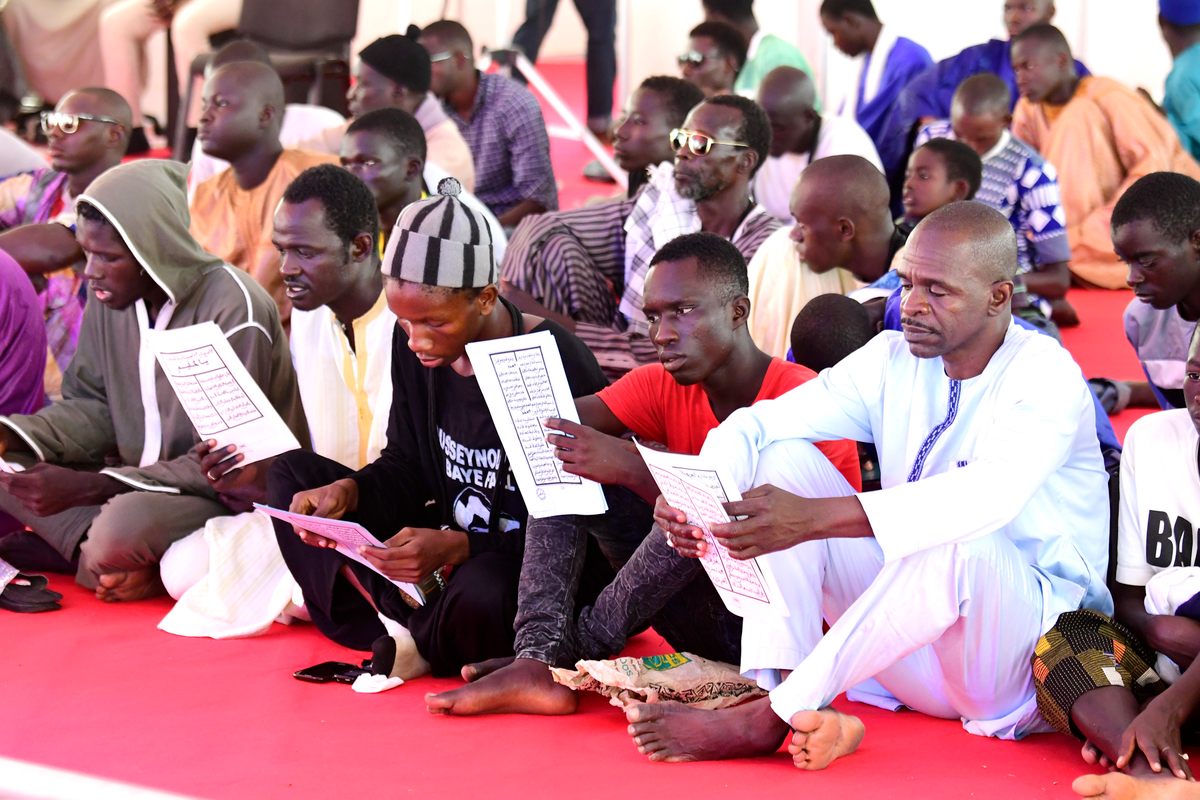 Pilgrims of the Mouride Brotherhood pray near the Great Mosque of Touba to honor Bamba and the time he spent in exile.