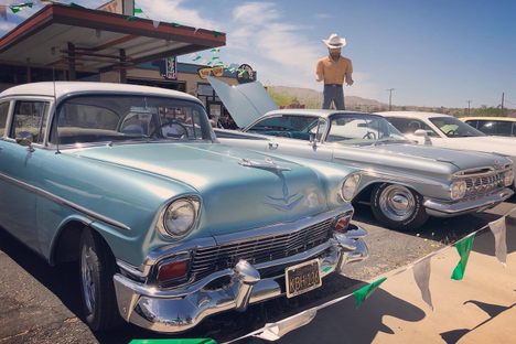 'Big Josh' stands watch over vintage cars.