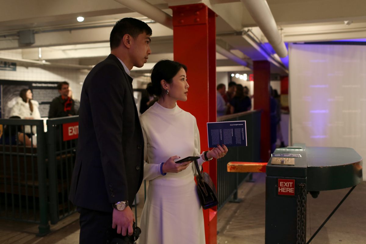 A finely dressed couple takes in the Transit Museum's surroundings.