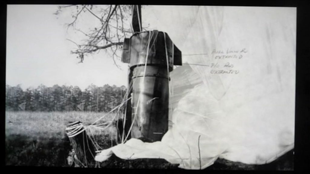 One of the bombs fell with its parachute deployed.