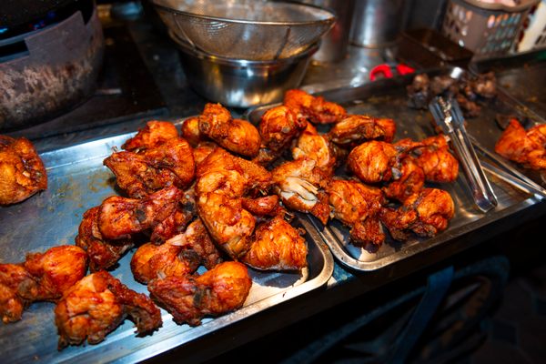 Chicken is marinated in an umami-forward brine before being battered and deep-fried.