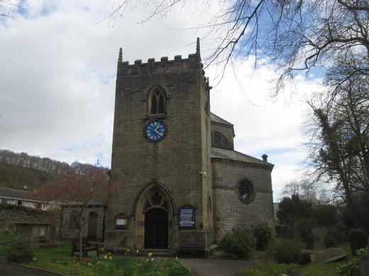 A stone clock tower is the entrance of an octagonal church