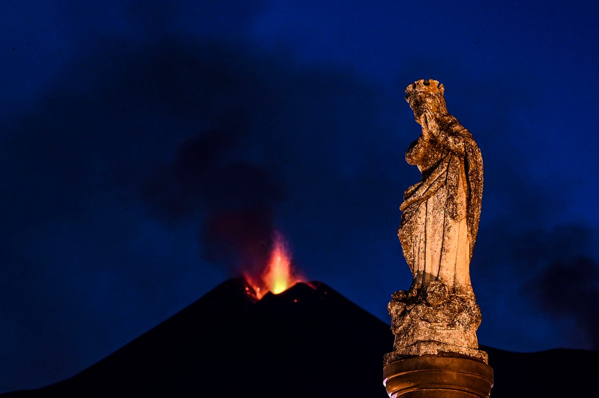 The statue of the Immaculate Madonna in Milo beside the not-so-distant eruption.