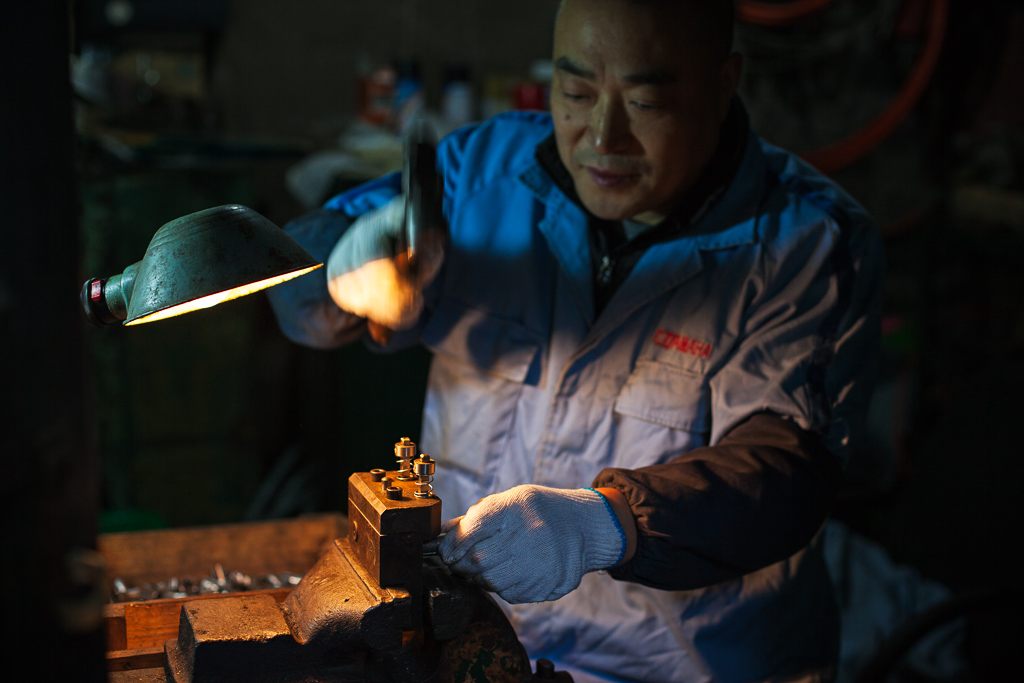 In the factory’s quality-control area, a worker checks the dimensions of the parts produced in the tunnels.