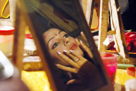 Likuma Sarma, a renowned mobile theater actor, does her makeup before taking the stage.