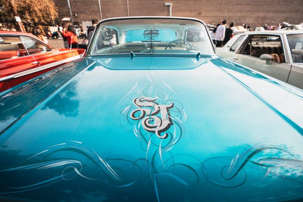 Lowriders are generally customized by their owners. The "SJ" on this '63 Chevy Impala is short for San Jose. The car owner also chose the color teal to celebrate the San Jose Sharks hockey team.