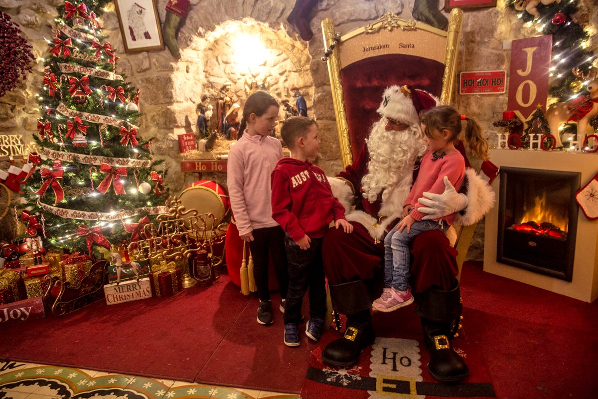 Kassissieh greets children as Santa in the afternoons, These children are from Ireland.