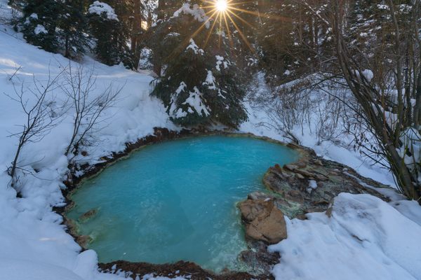 82 degree turquoise water boils forth from a pool seemingly carved out of the snow.