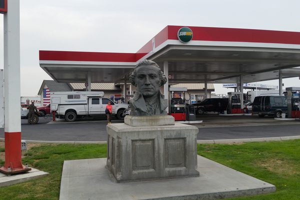 Bust in the corner under the sign
