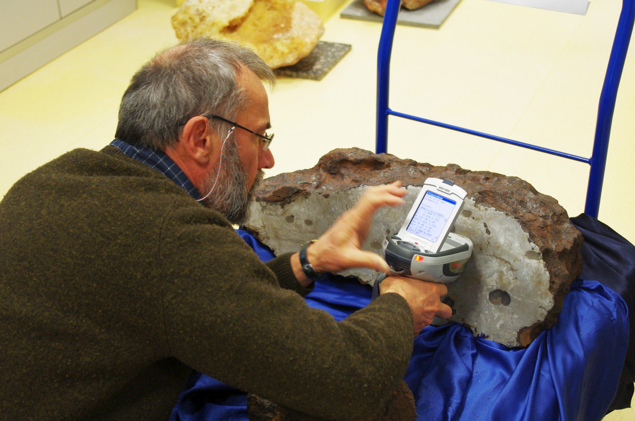 Albert Jambon assesses the metallic composition of a large meteorite from the Morasko Meteorite Nature Reserve in Poland.