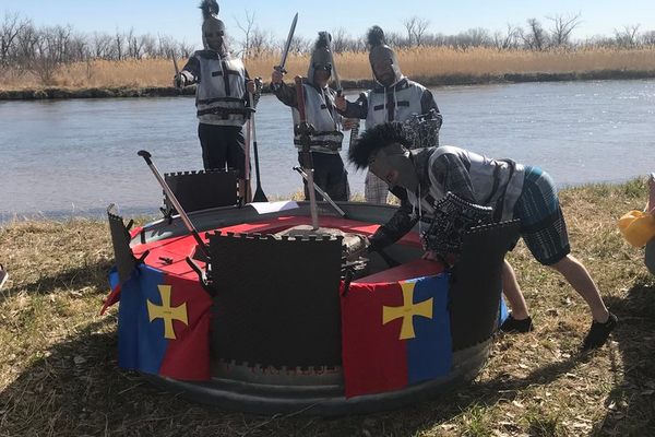 A group of medieval knights prepares to launch their tanking vessel into the slow-moving waters of Nebraska’s North Platte River. 