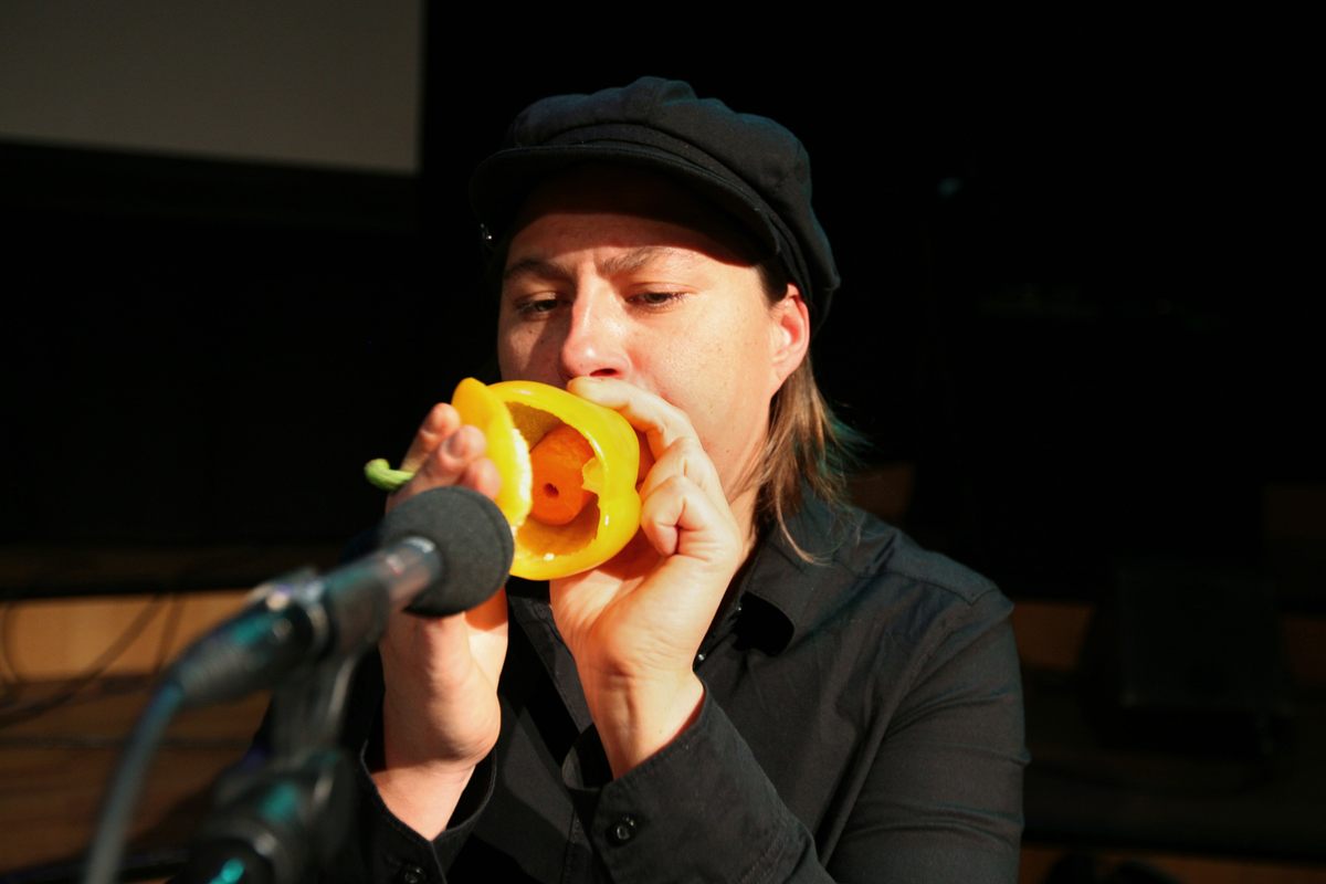 A performer blows into a pepper trumpet.