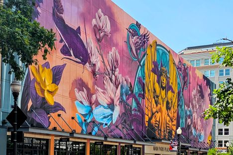 The mural takes up most of the length of a city block.