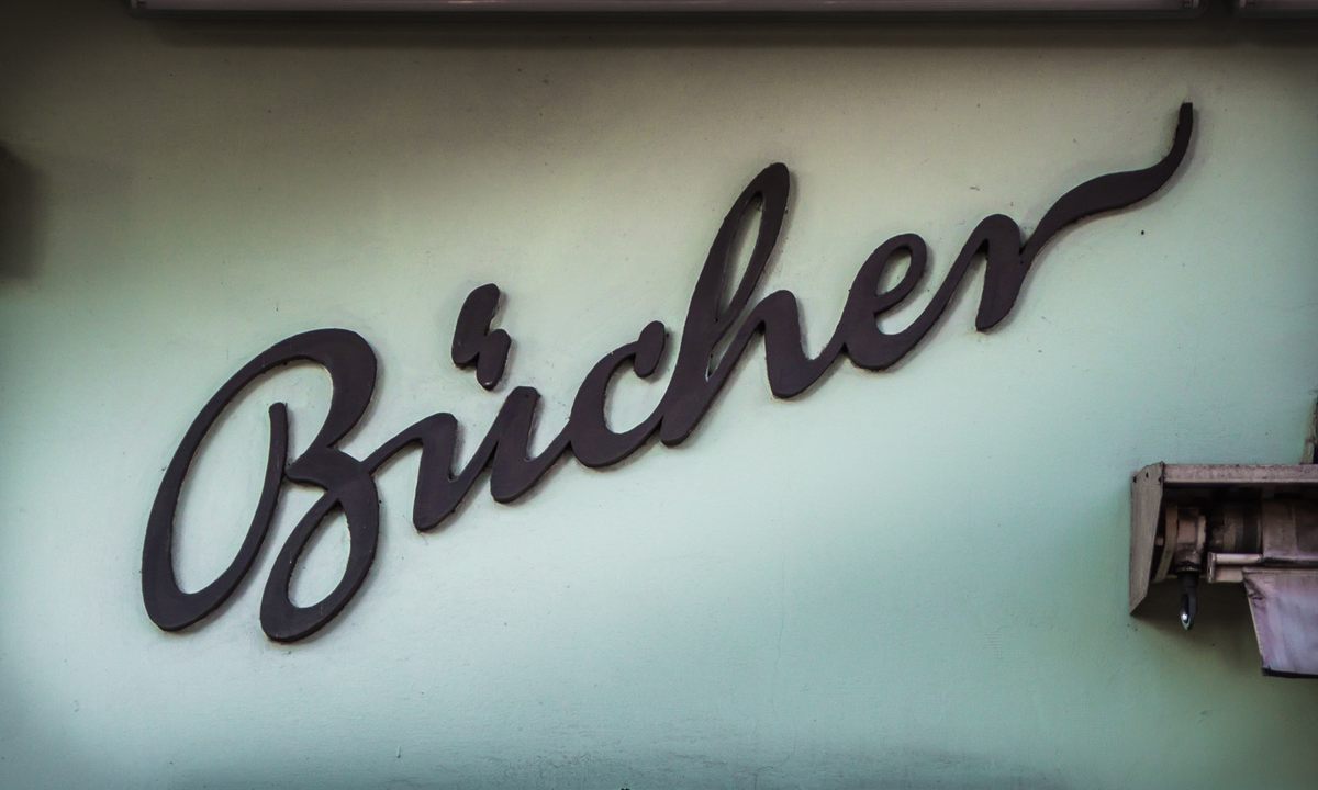 A sign for a bookstore with a lighting-stroke umlaut.