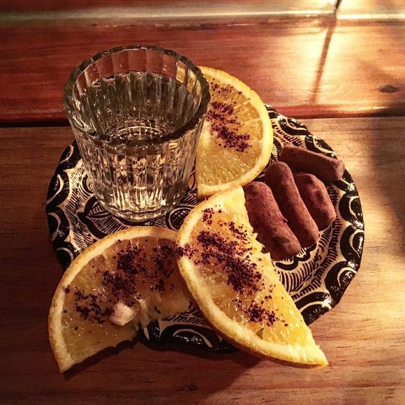 Pox is often served with coffee ground–dusted orange slices and a few pieces of cacao.