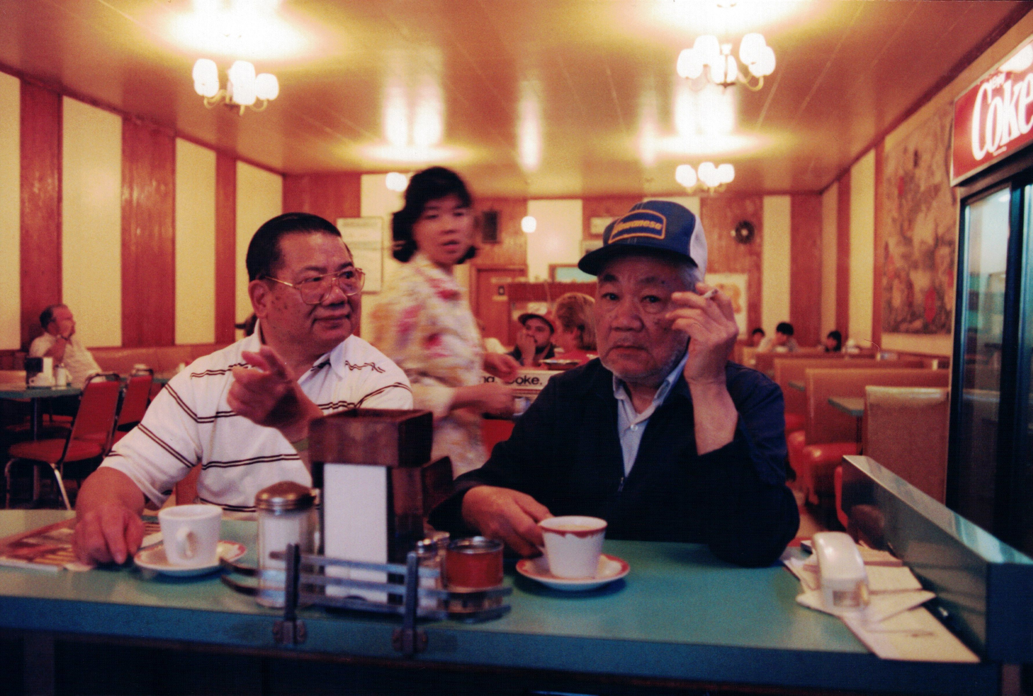 At New Outlook Café in Saskatchewan, Canada, Founder Noisy Jim sits with cousin Chow Fong.