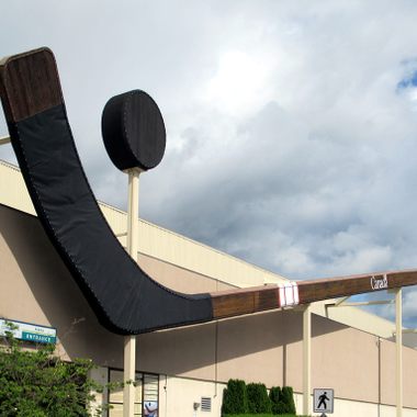 The World's Largest Hockey Stick & Puck hang on the side of the rink where the Cowichan Capitals Junior A Hockey Club plays in Duncan, British Columbia, Canada.