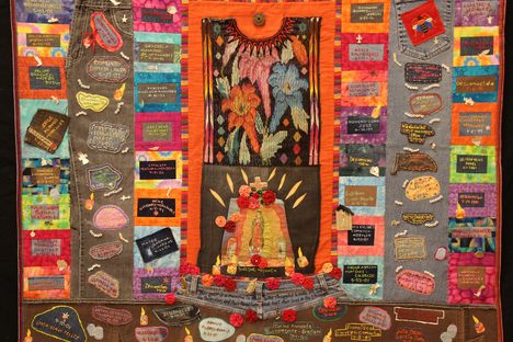 A quilt from the Migrant Quilt Project. The quilts list names of migrants who died in the Arizona desert and incorporate personal items found along migrant routes, such as jeans and handkerchiefs.