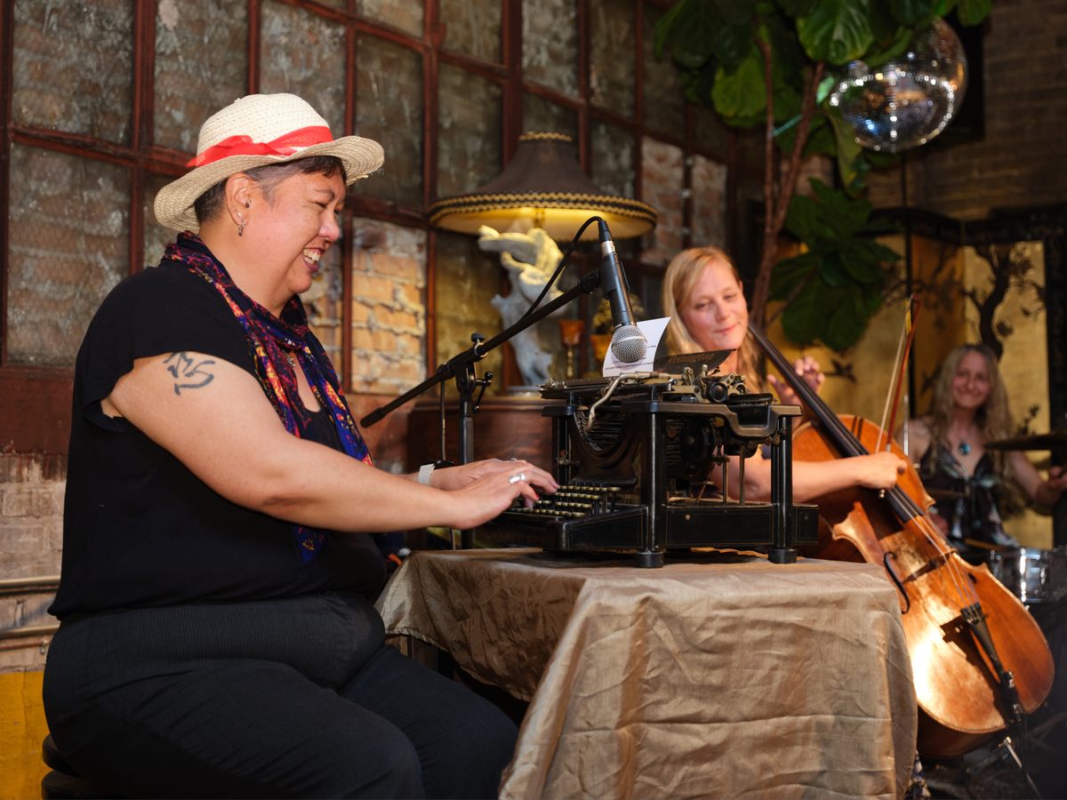 Poet Monica Thomas backs up Milwaukee folk punk band Nineteen Thirteen on a typewriter.