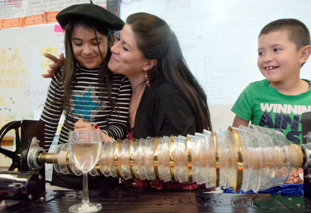 Armonica player Mayling Garcia demonstrates, for second graders in Albuquerque, New Mexico, the instrument Franklin invented.