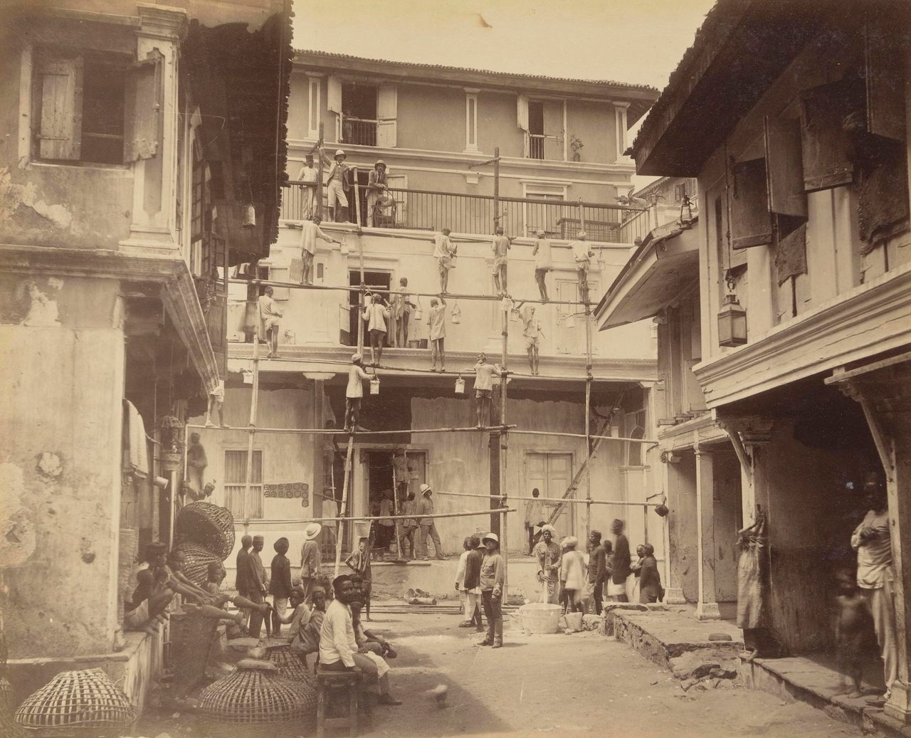 Workers clean a house in a neighborhood affected by the 1896 bubonic plague.