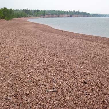 Pink rocks cover the beach.