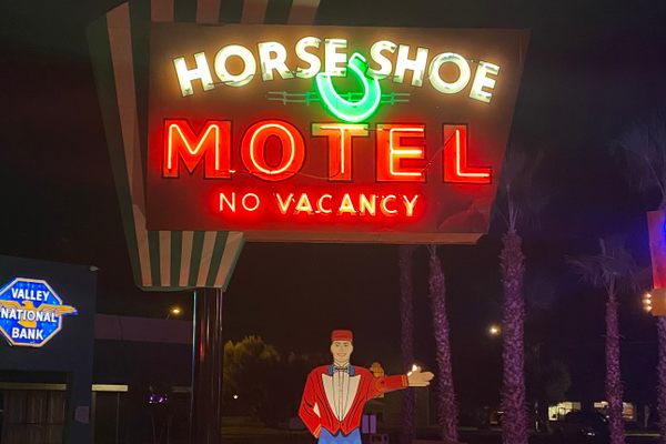 Horse Shoe Motel sign, 1953, with replica Paul the Waver. 