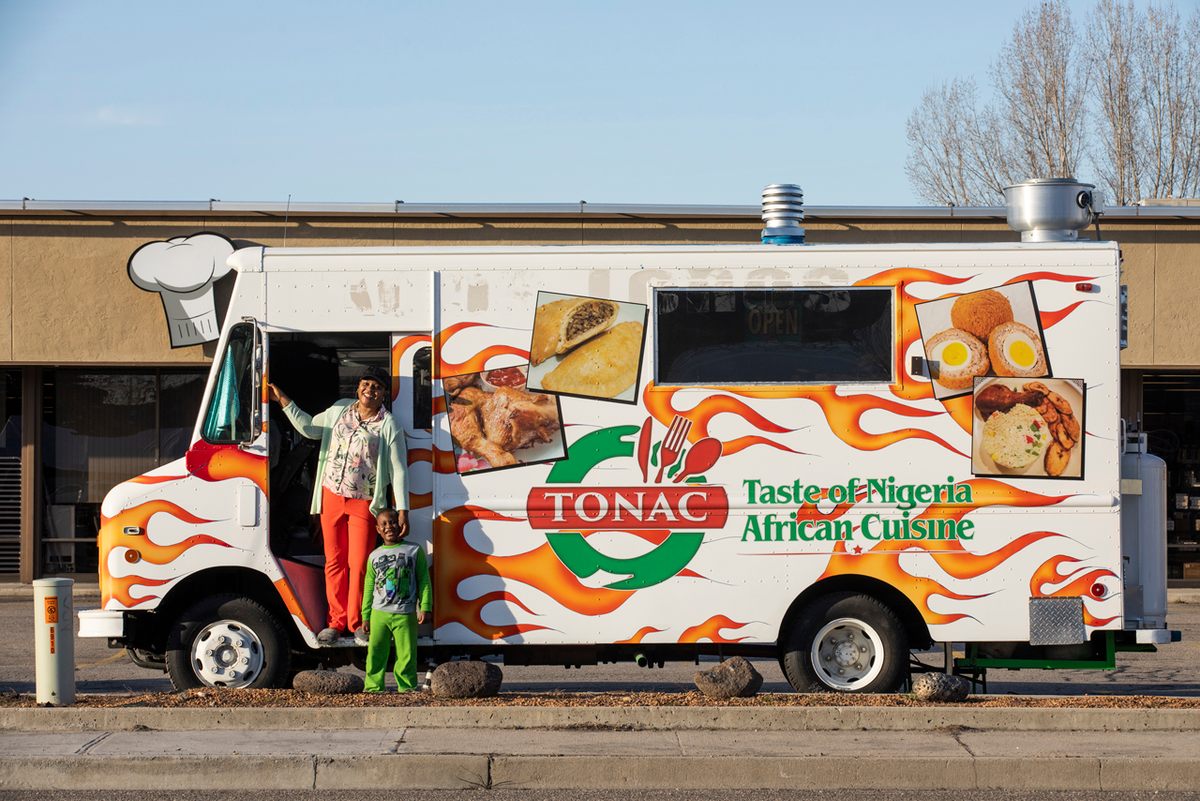 Zainab Abimbola and her son Ameer stand in front of her food truck Tonac (Taste of Nigeria African Cuisine).