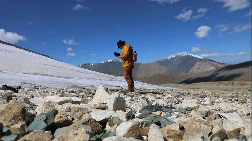 Archaeologist and paleoenvironmental researcher Isaac Hart of the University of Utah surveys a melting ice patch in western Mongolia.