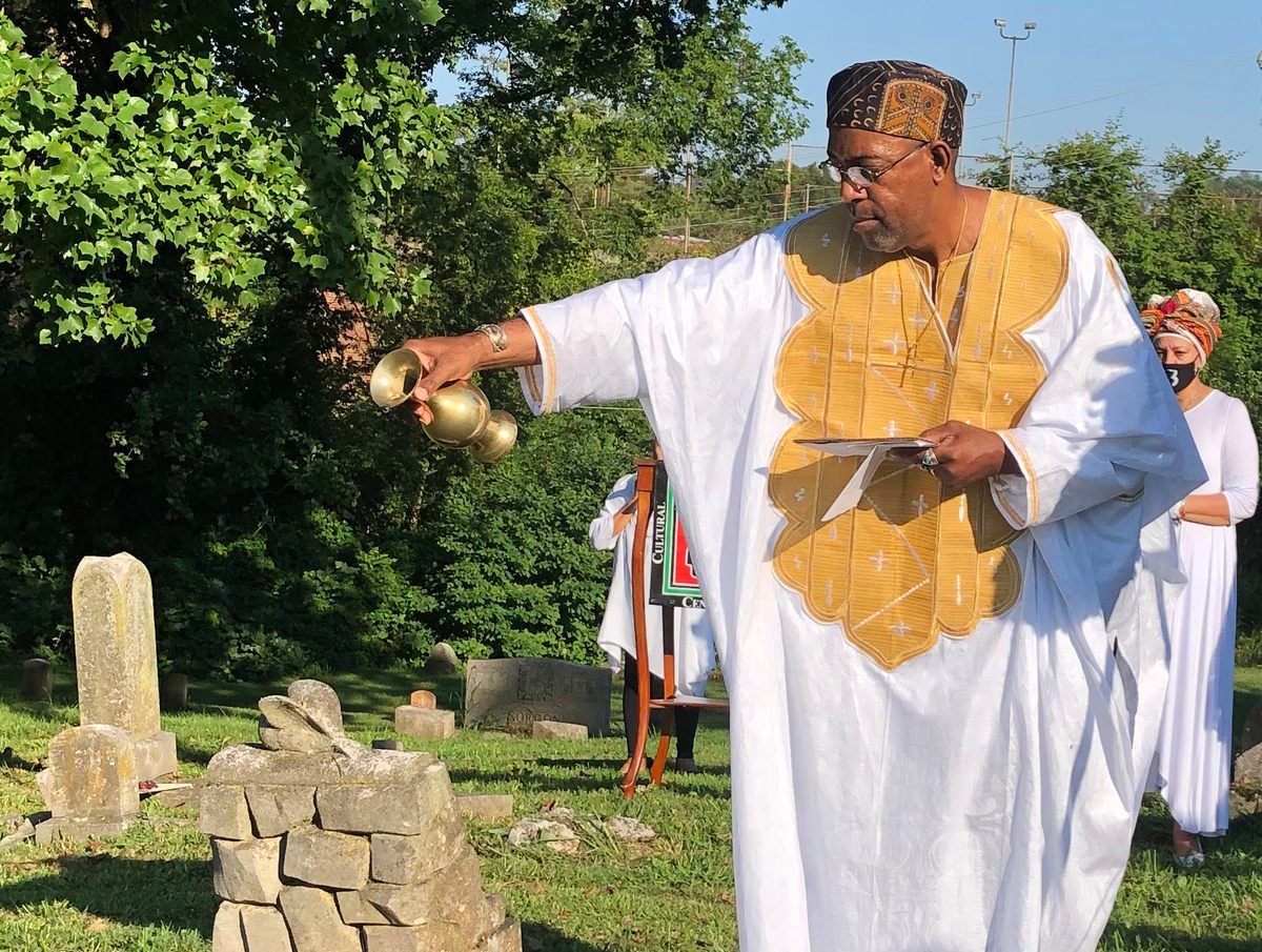 Reverend Alan Jones performing the Libation Ceremony over the grave of Lizzy Forby.