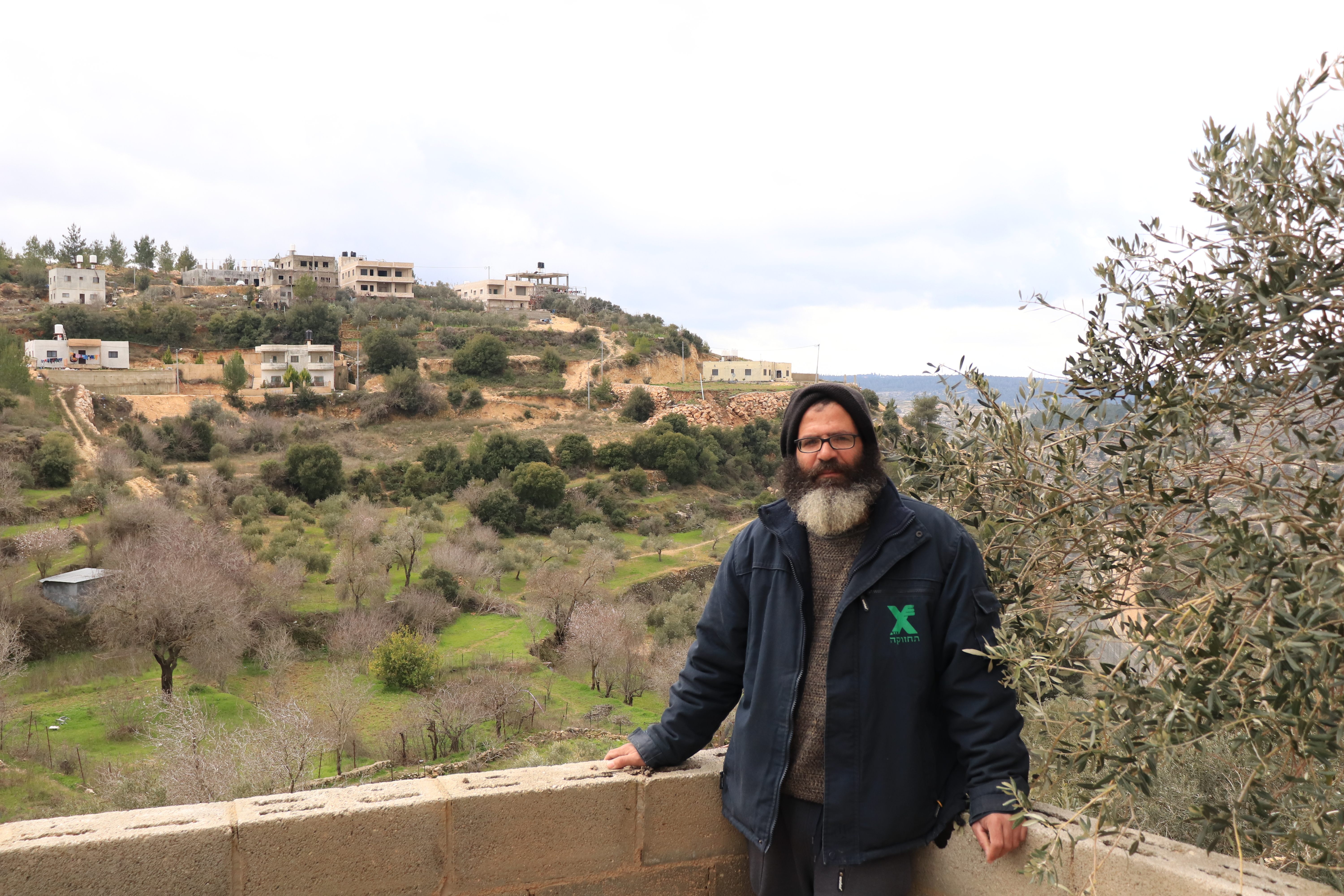 Salah Abu Ali, in front of his family's orchard. 