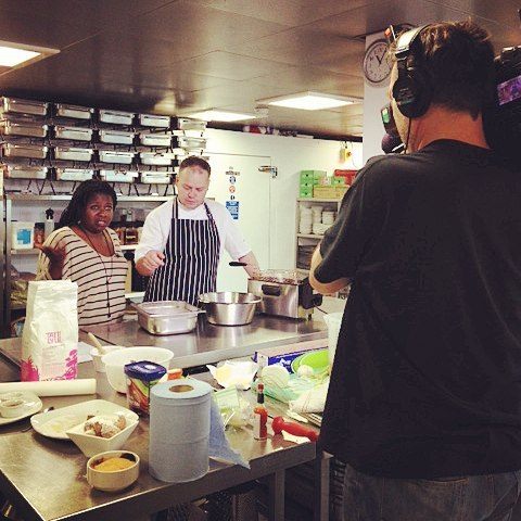 Archaeologist Peggy Brunache appears on a televised cooking festival.