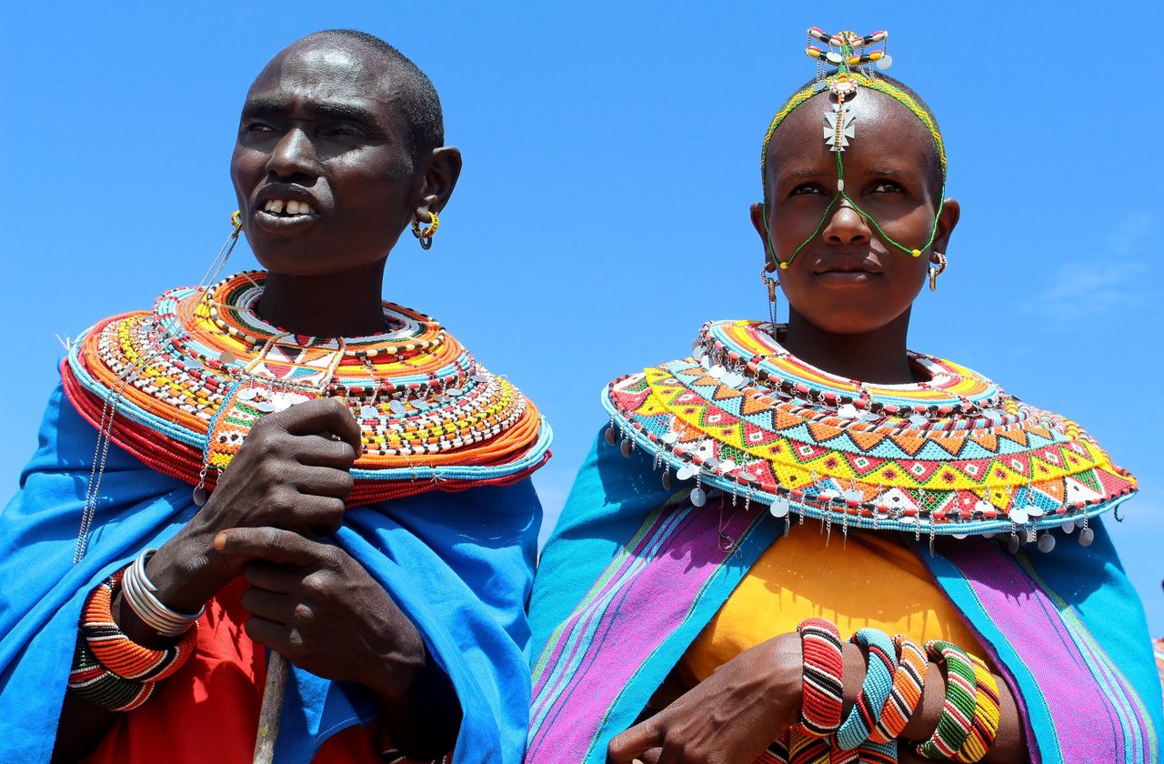 Two women pose wearing their intricate <em>mporo</em> necklaces.