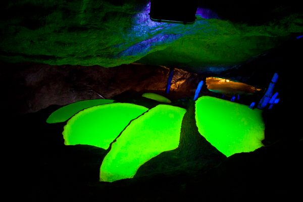Glowing water pools in Can Marça Cave