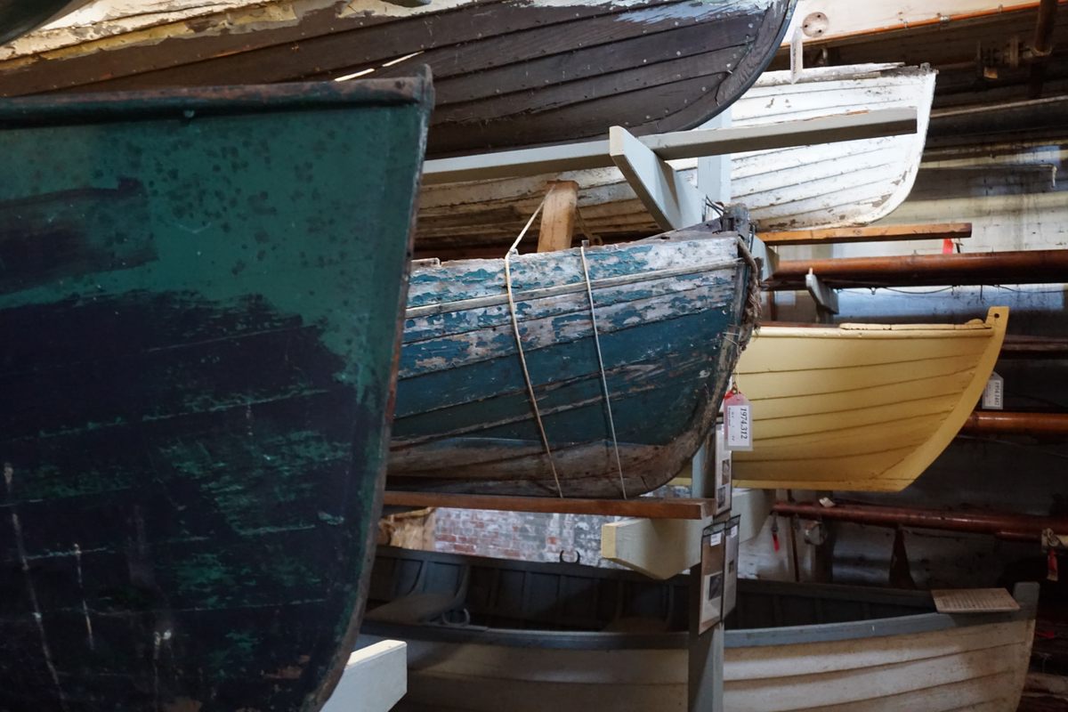 A range of rowing boats for work and pleasure, each with wear that shows a unique history of use.