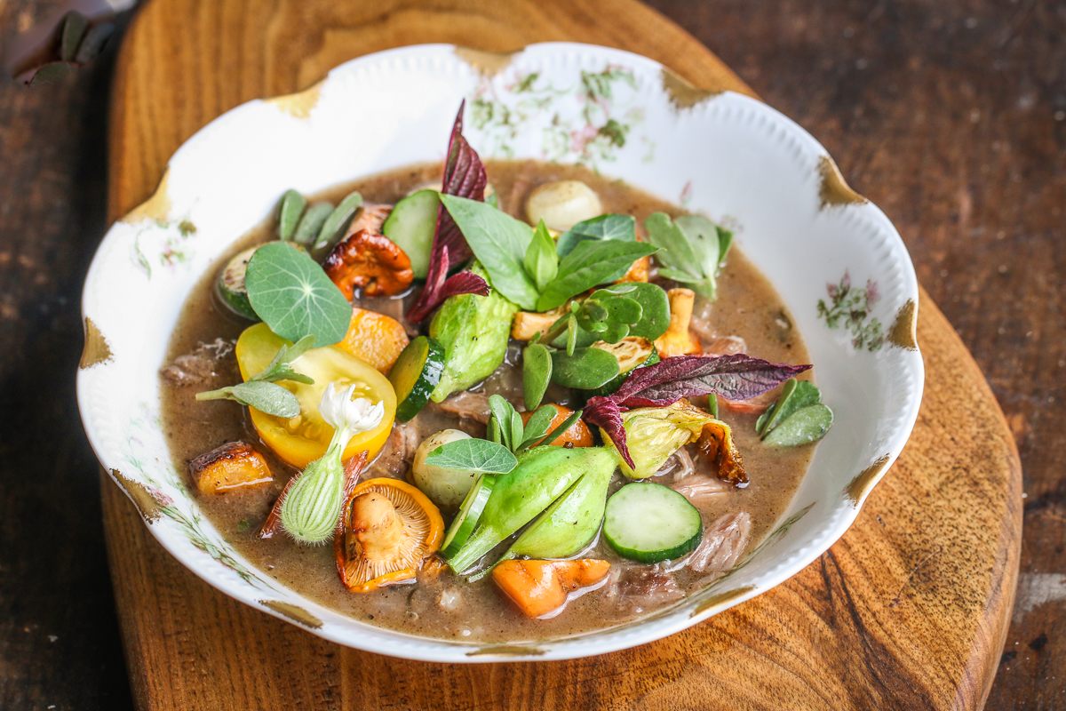 Bright, lightly sautéed veggies offset the richness of groundhog stew.