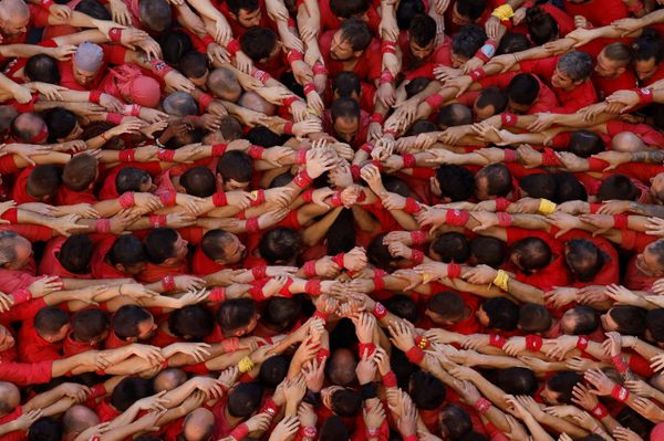 Members of Colla Joves Xiquets De Valls form the pinya, or foundation, of a human tower during a castell-building competition in Tarragona, Spain, earlier this month. 