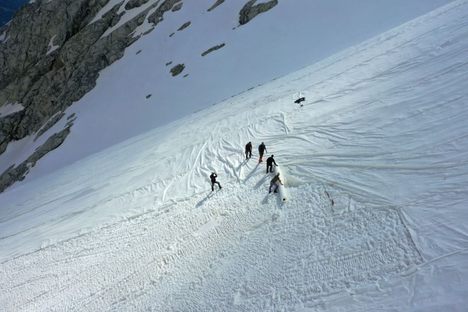 An aerial photo taken on June 19, 2020, shows workers covering the Presena glacier with huge geotextile sheets in northern Italy. 