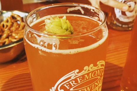 Many breweries have fresh hops lying around during the season. Here, a drinker garnished her fresh hope ale with a cone.
