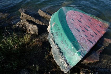 Names and messages left on the rock by passersby.