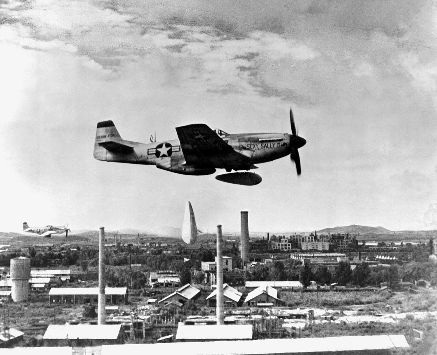 A P-51 dropping napalm bombs.