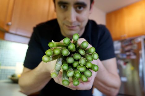 Pelling in the kitchen with asparagus, the veggie that inspired his work on spinal cord injuries.