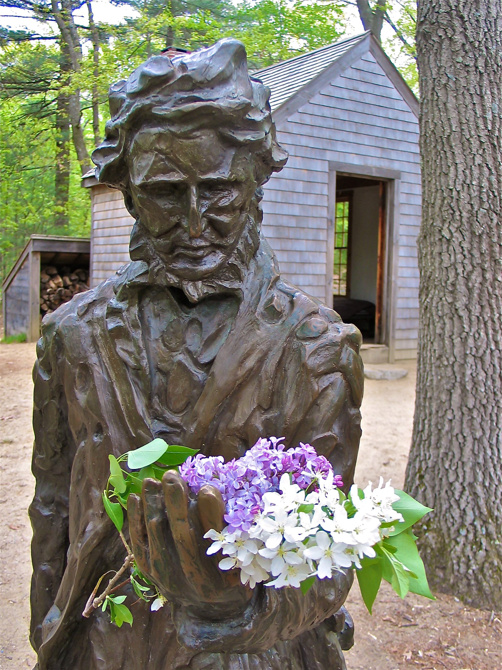A statue of the writer-botanist-philosopher, with wildflowers.