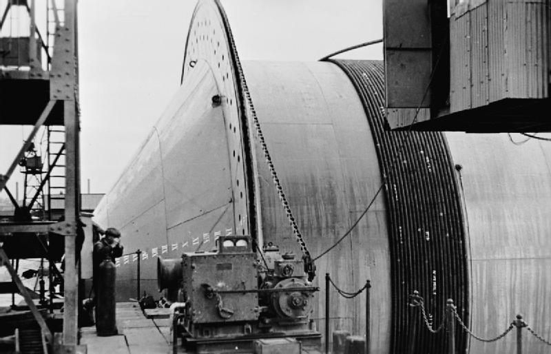 Pipelines coiled round a giant drum.